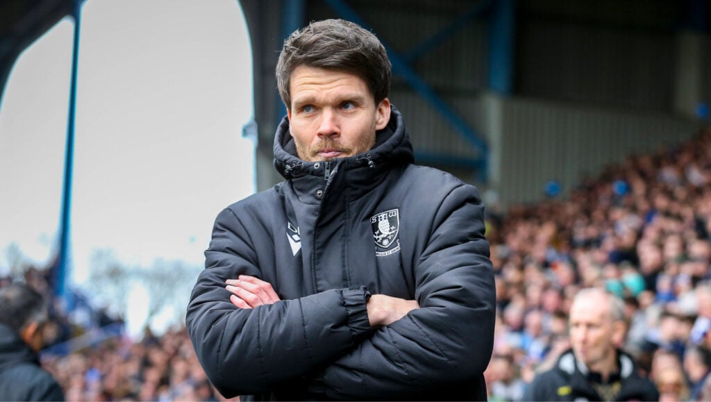 Rangers-linked former Sheffield Wednesday manager Danny Rohl stands on the touchline with his arms folded.