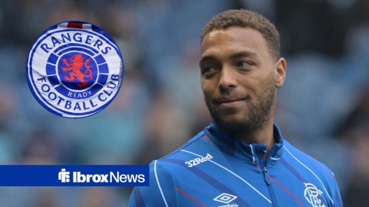 Cyriel Dessers smiles, with Rangers badge in circular frame