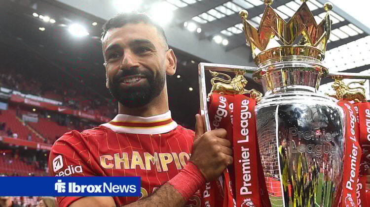 Liverpool forward Mohamed Salah holds the Premier League trophy.