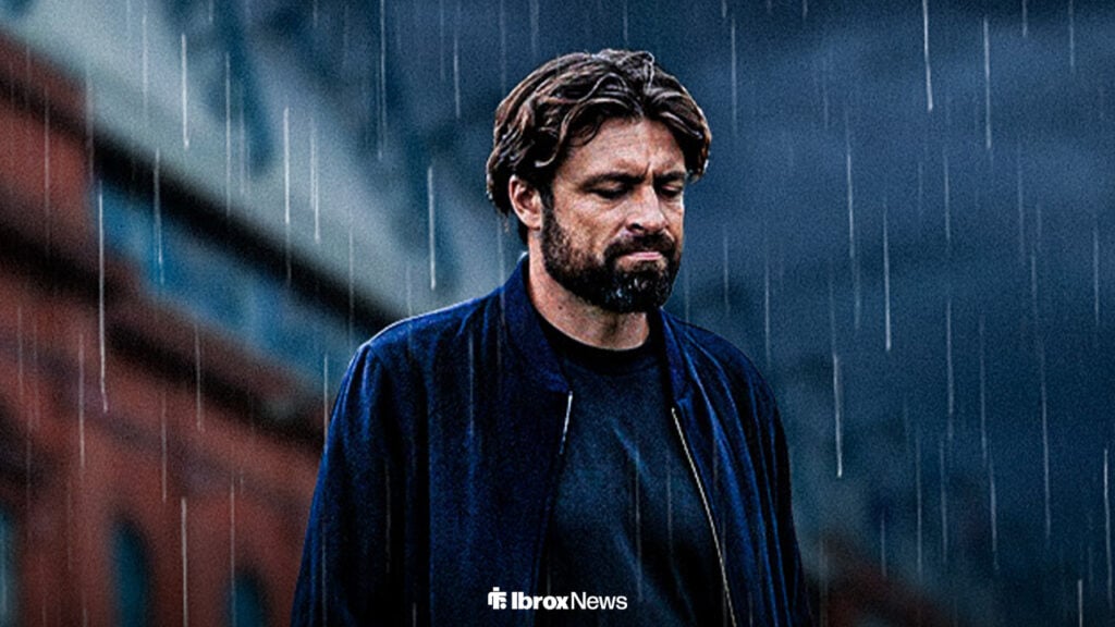 Rangers manager Russell Martin looks down outside of Ibrox in the rain