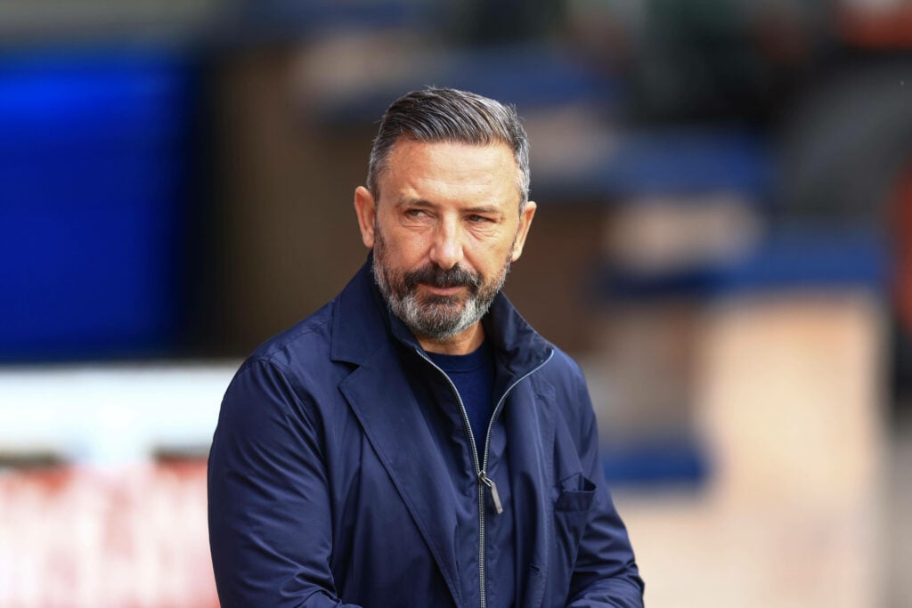 Rangers-linked Hearts manager Derek McInnes stares to his left while standing on the touchline.
