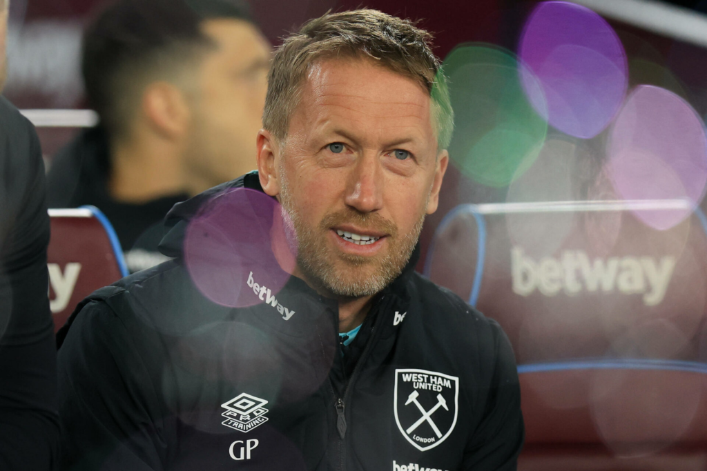 Graham Potter smiling from the West Ham dugout