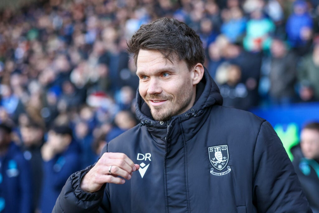Danny Rohl smiles on the touchline as he manages a Sheffield Wednesday game.