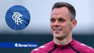 Lawrence Shankland smiling with Rangers badge in frame