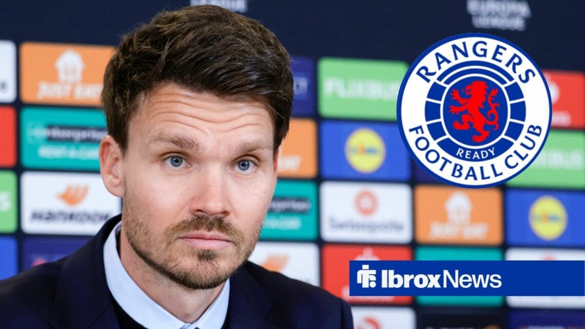 Danny Rohl looking at Rangers badge in circular inset