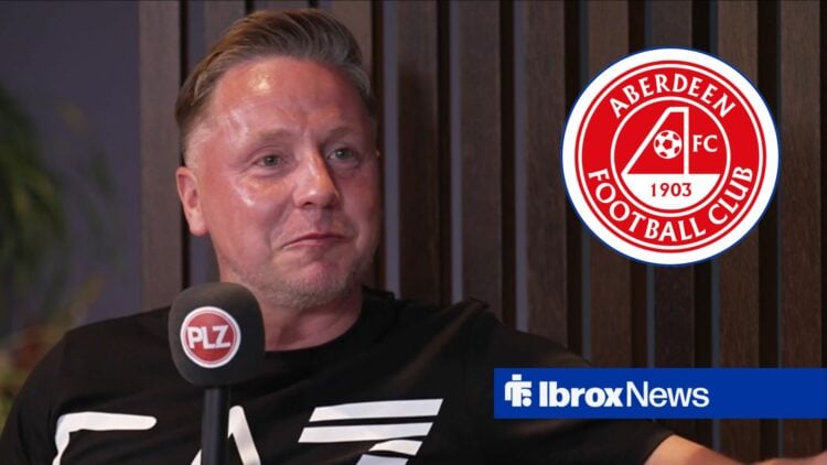 Tam McManus speaking looking towards a circle inset of the Aberdeen badge