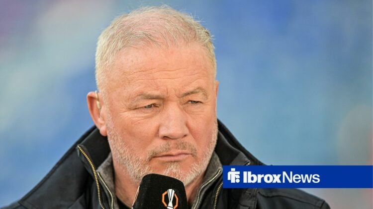 Ally McCoist with a microphone held to his mouth.