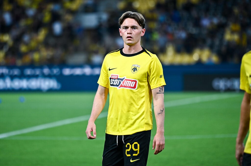 James Penrice straight-faced in home AEK Athens kit