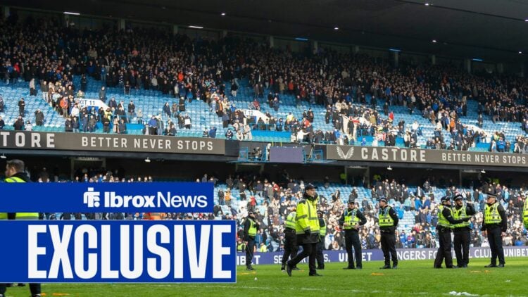 Police and stewards line the pitch as they try to regain order following the crowd trouble after the final whistle during the Scottish Gas Scottish...