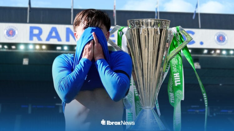 Mikey Moore has his head in his hands, with the Scottish Premiership trophy behind him